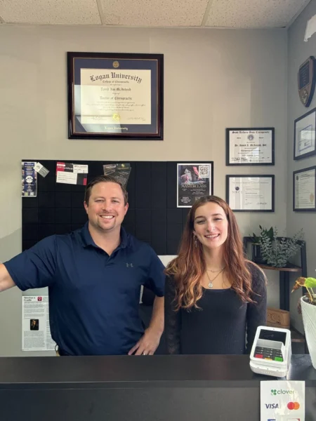 Patient visiting a chiropractor for a back pain consultation at a chiropractic clinic reception before starting back therapy.